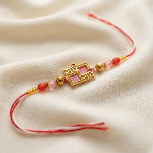 Divine Radhe Krishna Gold Rakhi with Pink Enamel & Red Beads