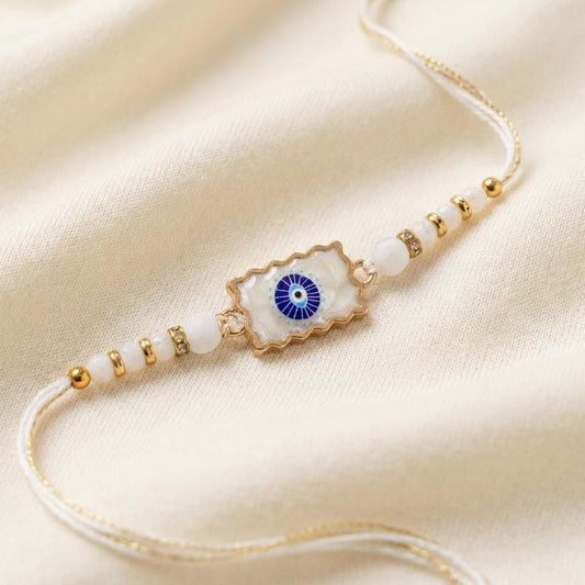 Elegant Gold Scalloped Evil Eye Stone Rakhi with Crystal Beads