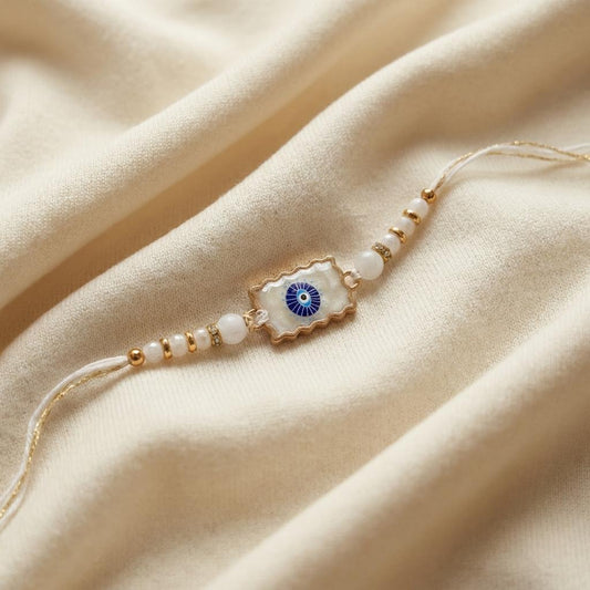 Elegant Gold Scalloped Evil Eye Stone Rakhi with Crystal Beads
