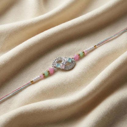Elegant CZ Infinity Designer Rakhi with Pastel Beads for Brother