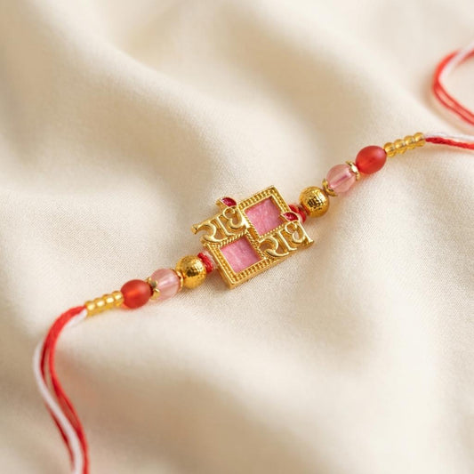 Divine Radhe Krishna Gold Rakhi with Pink Enamel & Red Beads