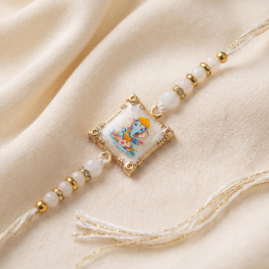 Handcrafted Ganesha Art Rakhi with Real White Stone & Gold Frame
