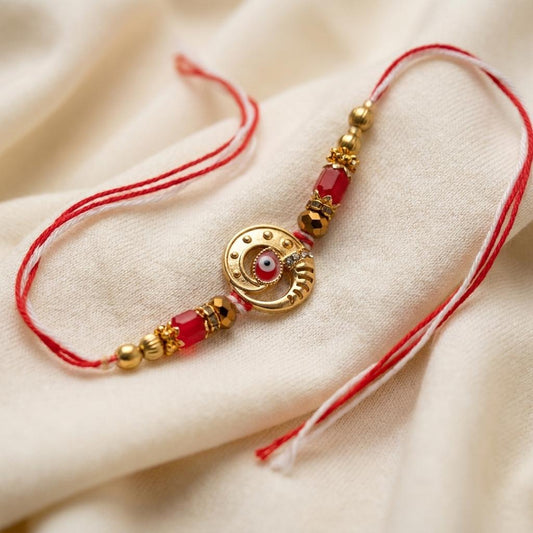 Handcrafted Evil Eye Rakhi with Red & Gold Beaded Thread - selfie to print