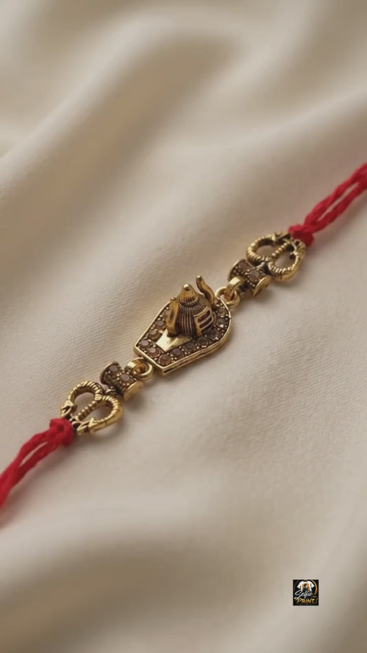 Sacred Shivling Antique Gold Rakhi with Red Twisted Thread