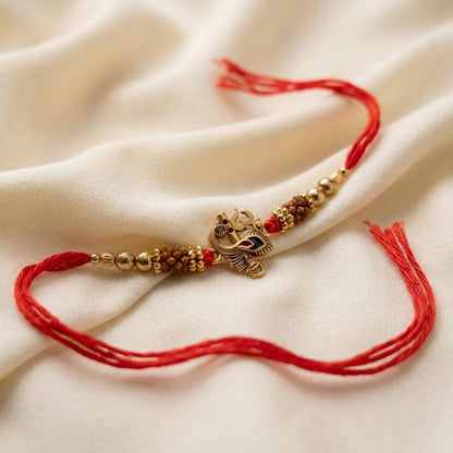 Traditional Gold Om Peacock Feather Red Thread Rakhi for Brother - selfie to print