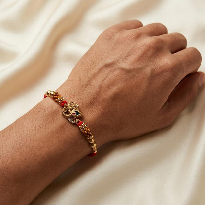 Traditional Gold Om Peacock Feather Red Thread Rakhi for Brother - selfie to print